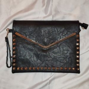 Black wristlet with gold accessories